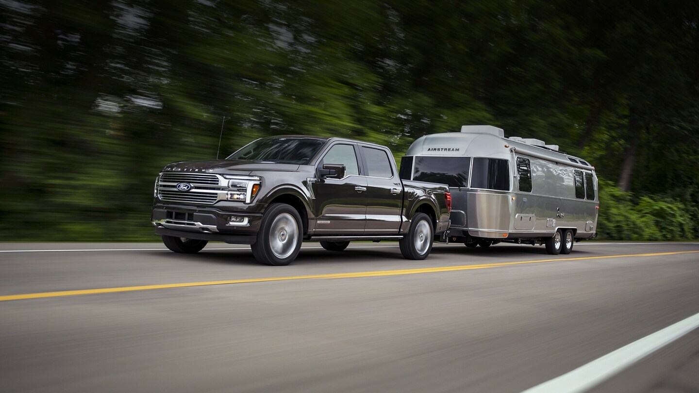 2024 F-150® Platinum® pickup pulling a camper trailer
